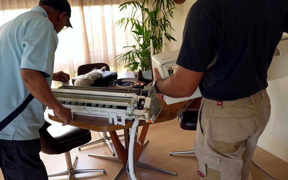 Vivek Refrigeration technicians servicing a split system indoor unit