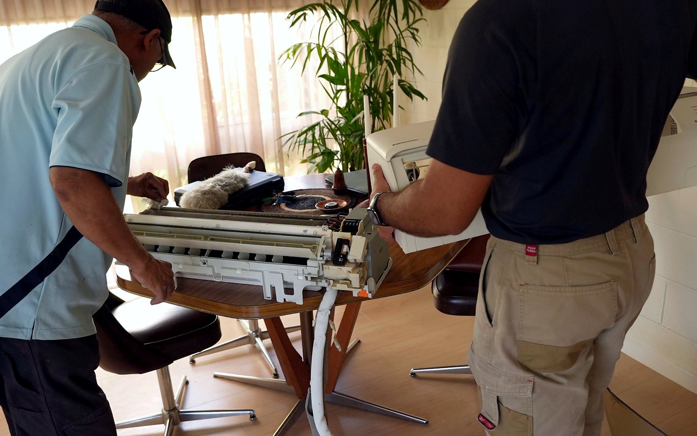 Vivek Refrigeration technician servicing a split system indoor unit